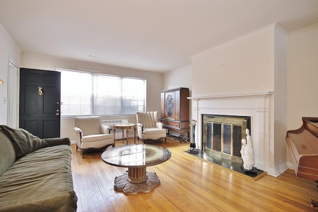 living room with hardwood / wood-style floors and ornamental molding