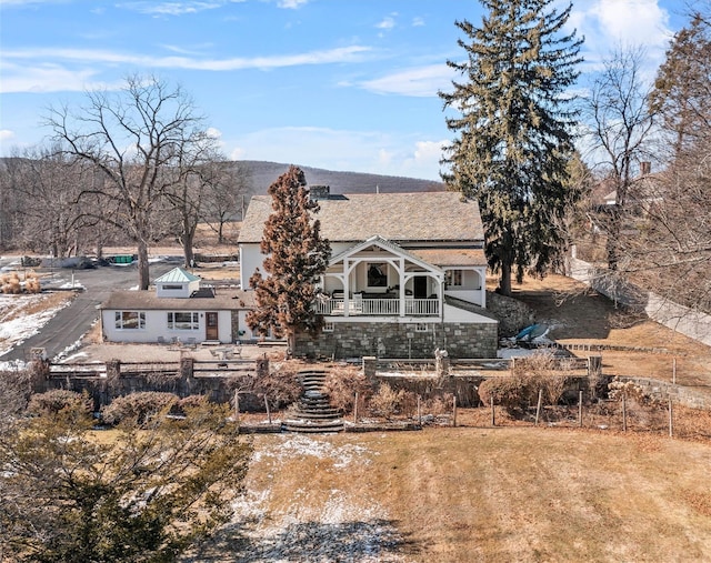 rear view of house featuring fence