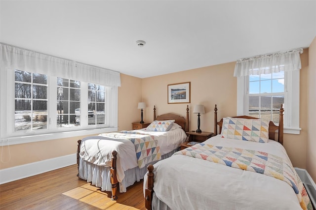 bedroom with baseboards and light wood-style floors