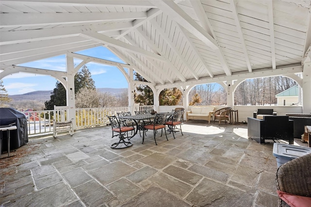 view of patio / terrace with outdoor dining space, outdoor lounge area, a mountain view, and area for grilling