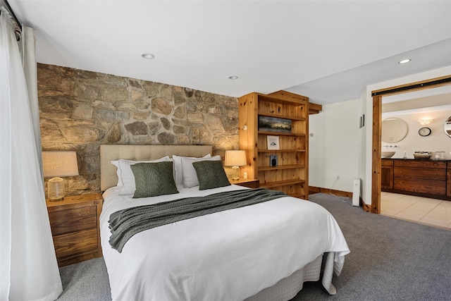 bedroom featuring ensuite bathroom, recessed lighting, baseboards, and light colored carpet