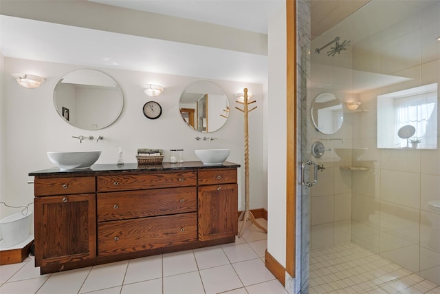 bathroom featuring double vanity, a sink, and a shower stall