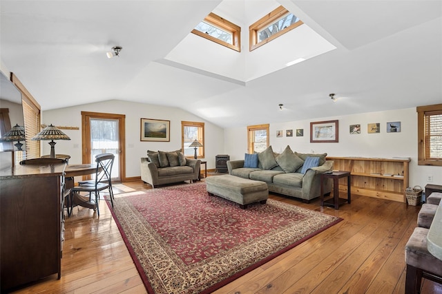 living room with lofted ceiling with skylight and wood finished floors