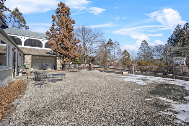 view of yard featuring a garage and fence