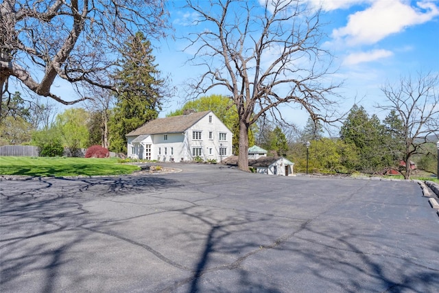 100 Pleasant Hill Rd, New Windsor, NY 12553 - back of house featuring a yard and asphalt driveway