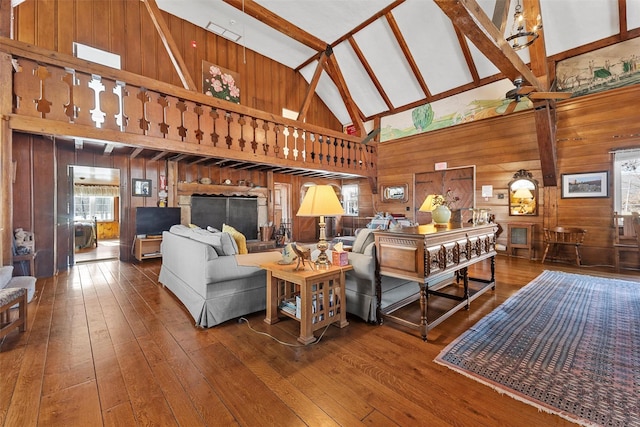 100 Pleasant Hill Rd, New Windsor, NY 12553 - living room with high vaulted ceiling, wooden walls, hardwood / wood-style floors, and beamed ceiling