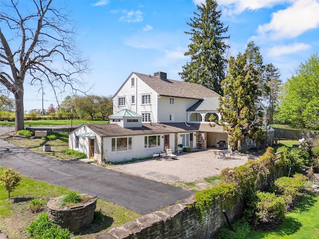 100 Pleasant Hill Rd, New Windsor, NY 12553 - rear view of house with a chimney, dirt driveway, fence, and a shingled roof