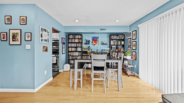 dining space with light hardwood / wood-style flooring