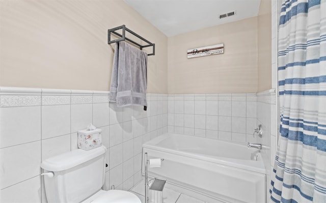 bathroom featuring tile walls, plus walk in shower, and toilet