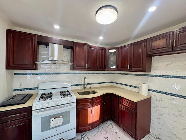 kitchen featuring white range with gas cooktop, wall chimney range hood, decorative backsplash, and sink