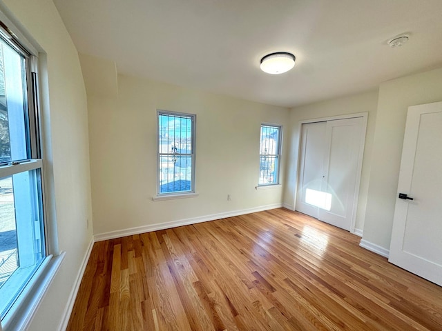 unfurnished bedroom featuring a closet and light hardwood / wood-style flooring