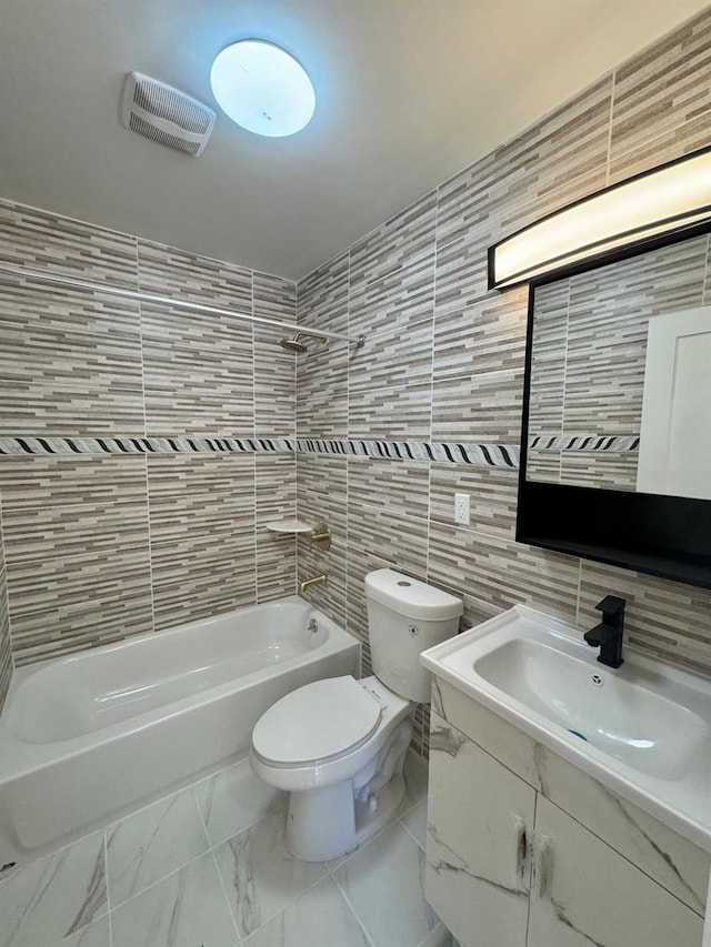 full bathroom featuring vanity, toilet, tile walls, and shower / bathing tub combination