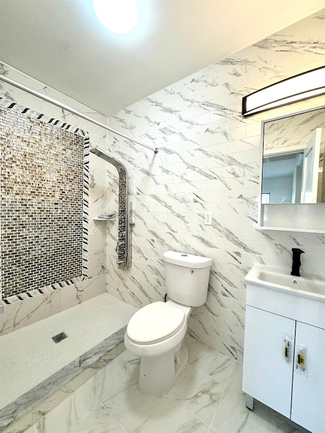 bathroom with vanity, toilet, and a tile shower