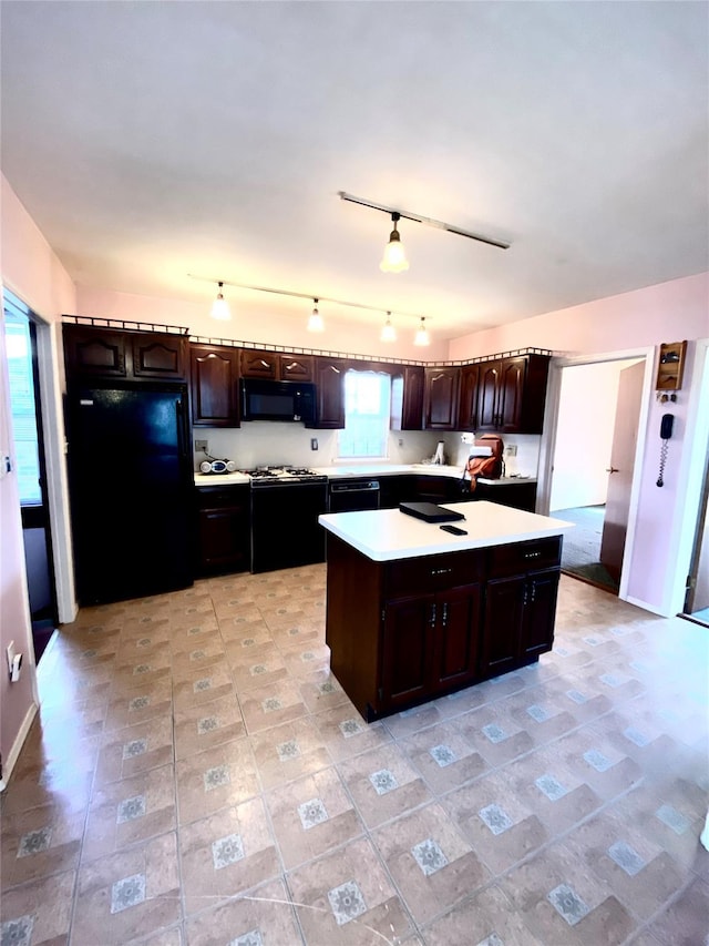 kitchen featuring dark brown cabinetry, black appliances, and a kitchen island