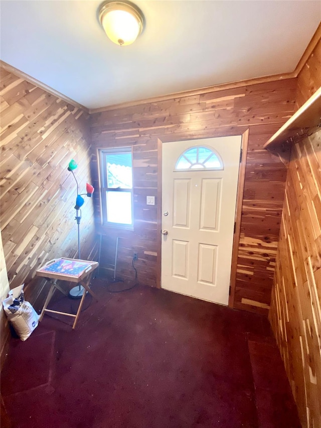 entryway with wood walls