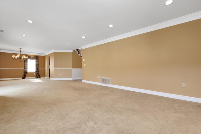 carpeted spare room featuring an inviting chandelier and crown molding