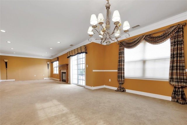 unfurnished living room with a notable chandelier, ornamental molding, and carpet flooring