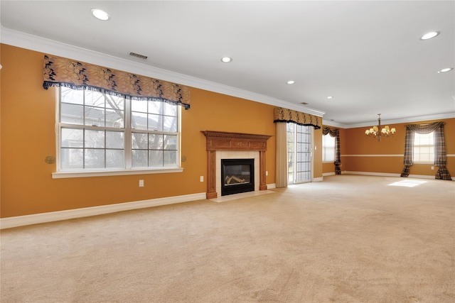 unfurnished living room featuring a tiled fireplace, crown molding, and light colored carpet