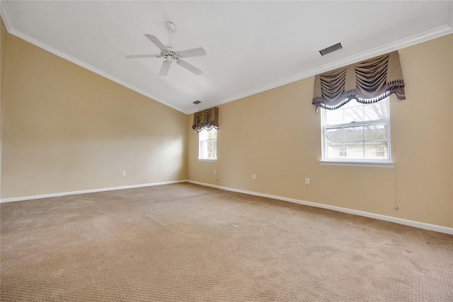 carpeted spare room featuring ceiling fan, lofted ceiling, and ornamental molding