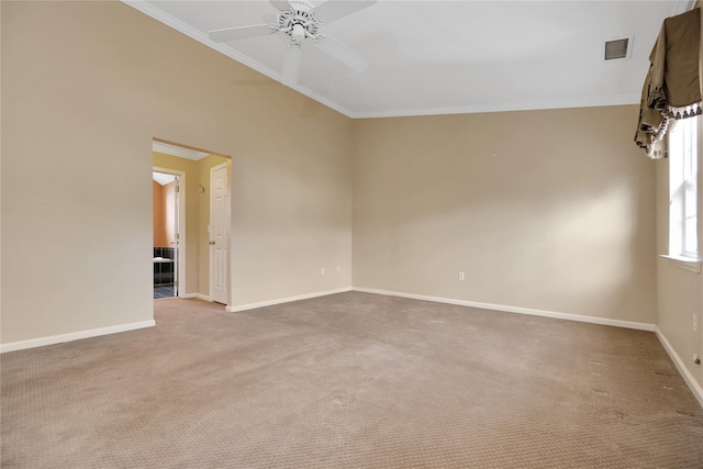 carpeted spare room with crown molding and ceiling fan