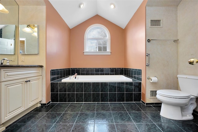 bathroom with tile patterned flooring, a relaxing tiled tub, vanity, vaulted ceiling, and toilet