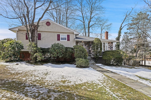 view of front of house featuring a chimney