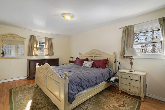 bedroom featuring dark wood-type flooring and baseboards