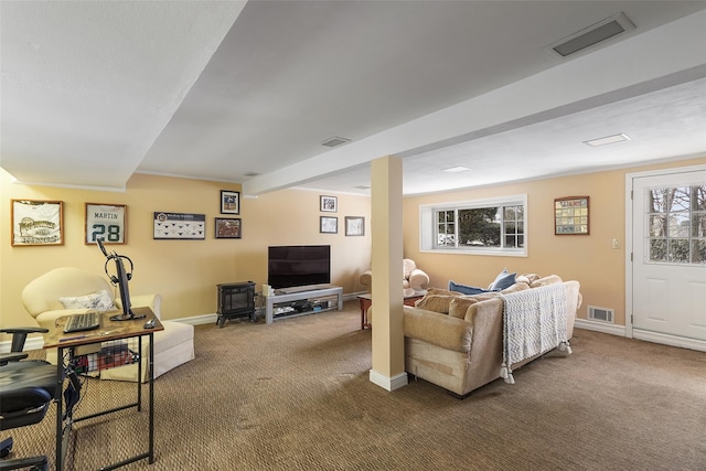 carpeted living area featuring visible vents and baseboards