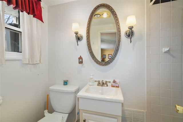 full bathroom featuring toilet, visible vents, and vanity