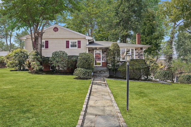 tri-level home with a front yard and a chimney