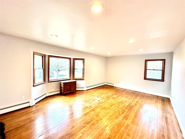 spare room with light hardwood / wood-style flooring and a baseboard heating unit