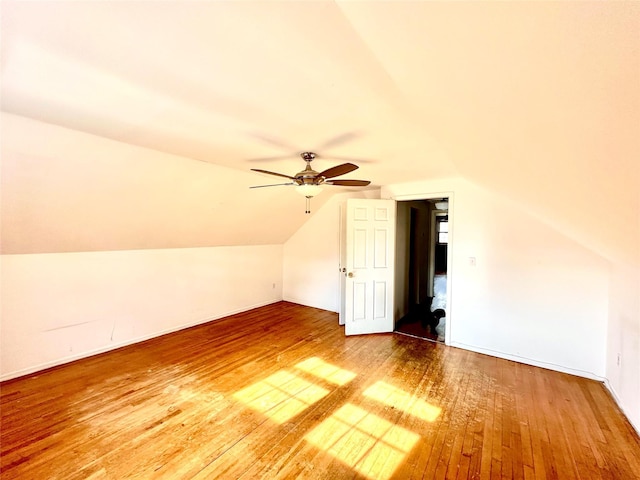 additional living space featuring vaulted ceiling, hardwood / wood-style floors, and ceiling fan