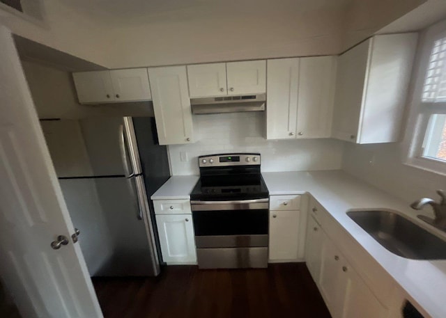 kitchen featuring stainless steel appliances, white cabinetry, sink, and dark wood-type flooring