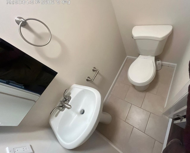 bathroom featuring sink, tile patterned floors, and toilet