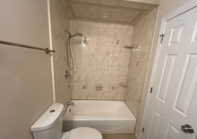 bathroom with tiled shower / bath combo and toilet