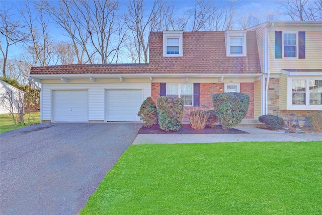 view of front of home featuring a garage and a front lawn