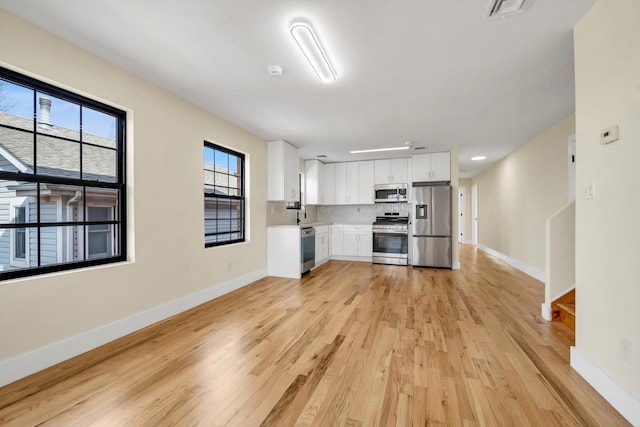 unfurnished living room with light wood-type flooring