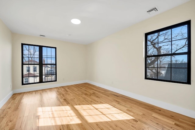 unfurnished room with light hardwood / wood-style flooring