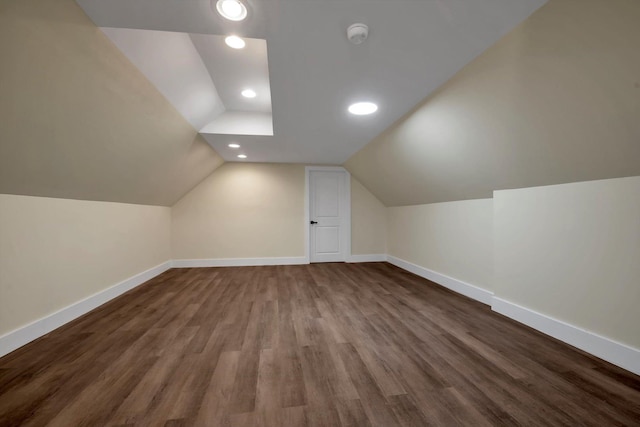 additional living space featuring hardwood / wood-style flooring and vaulted ceiling