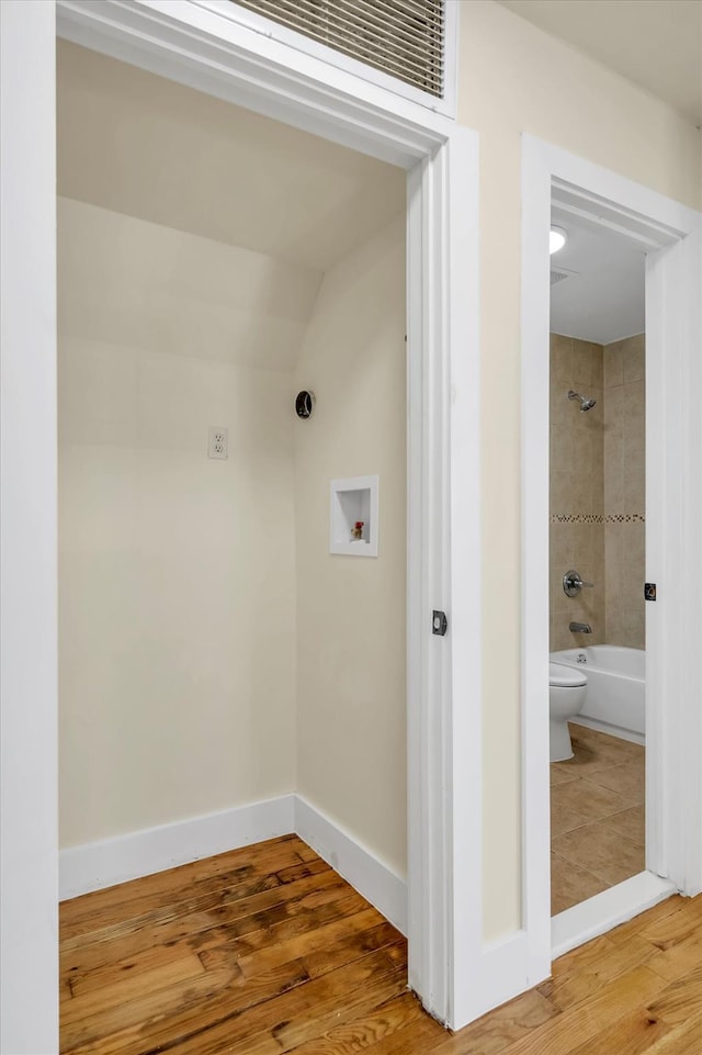 laundry room featuring hardwood / wood-style flooring and hookup for a washing machine