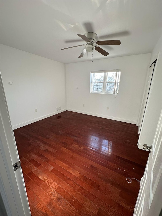 interior space with ceiling fan and dark wood-type flooring