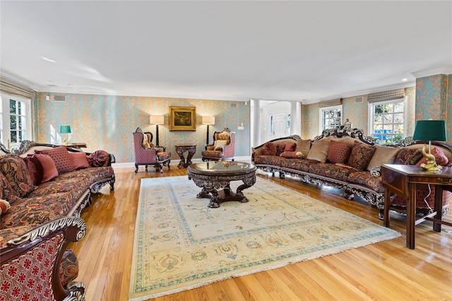 living room with crown molding and light hardwood / wood-style floors