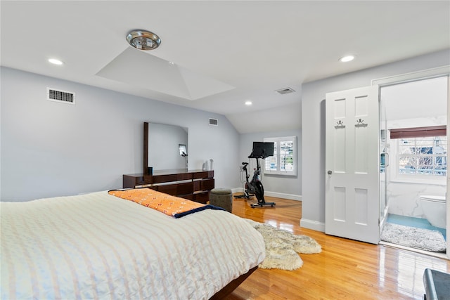 bedroom featuring lofted ceiling and light wood-type flooring