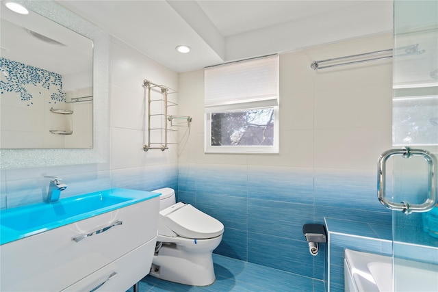 bathroom featuring vanity, toilet, and tile walls