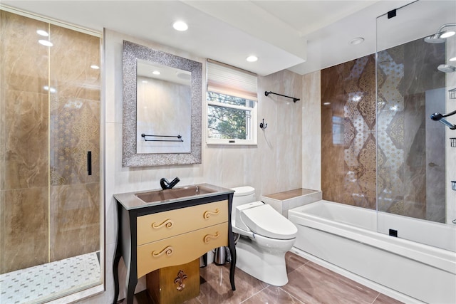 full bathroom featuring shower with separate bathtub, tile walls, vanity, and toilet