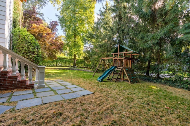 view of playground with a lawn