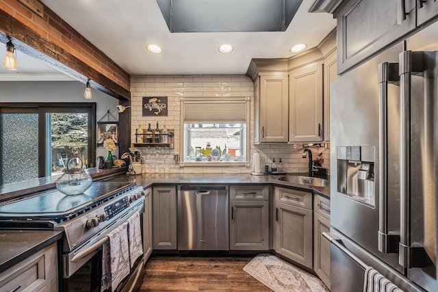 kitchen with appliances with stainless steel finishes, sink, decorative backsplash, and plenty of natural light