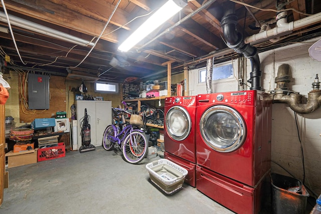 basement with washing machine and clothes dryer and electric panel