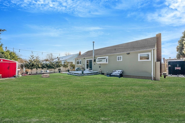 rear view of house featuring a yard