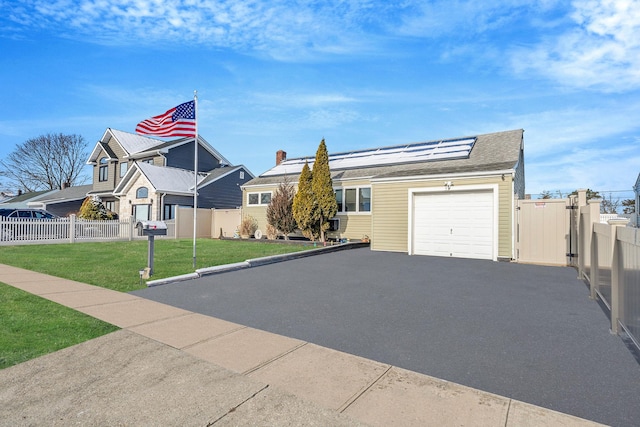 view of front of home featuring a garage and a front lawn